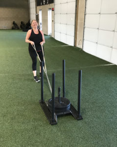 wendy using her coaches to make sure her form is right with the sled